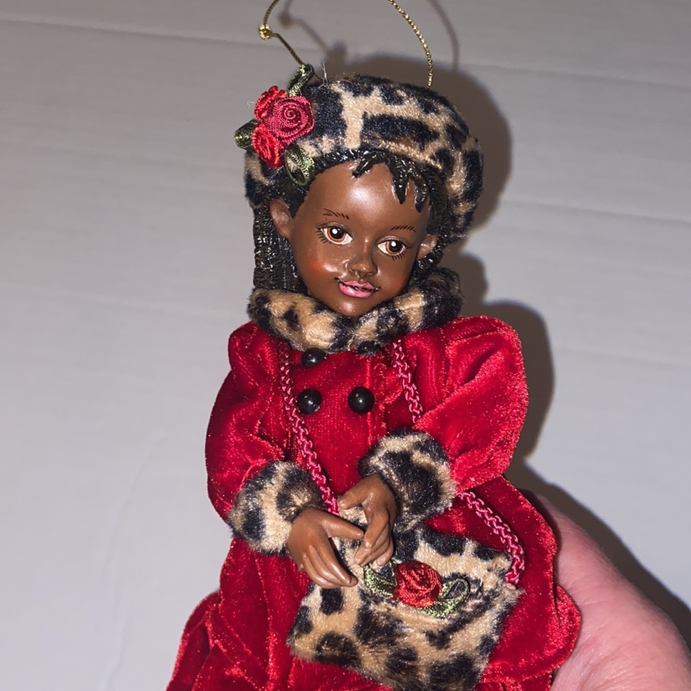 Vintage African American doll ornament with red velvet and leopard fur purse